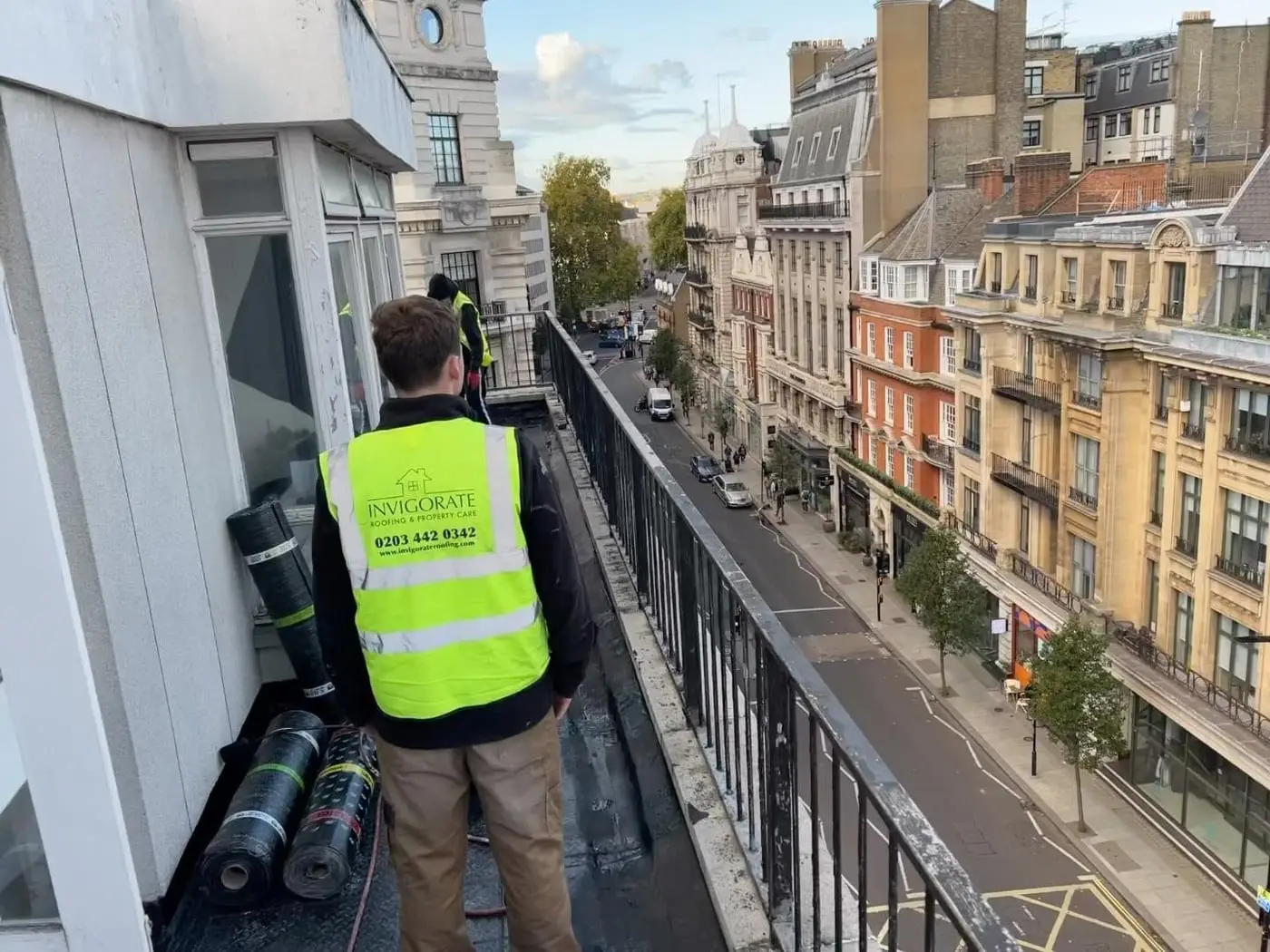 Invigorate Roofing team member working at height above a Central London street