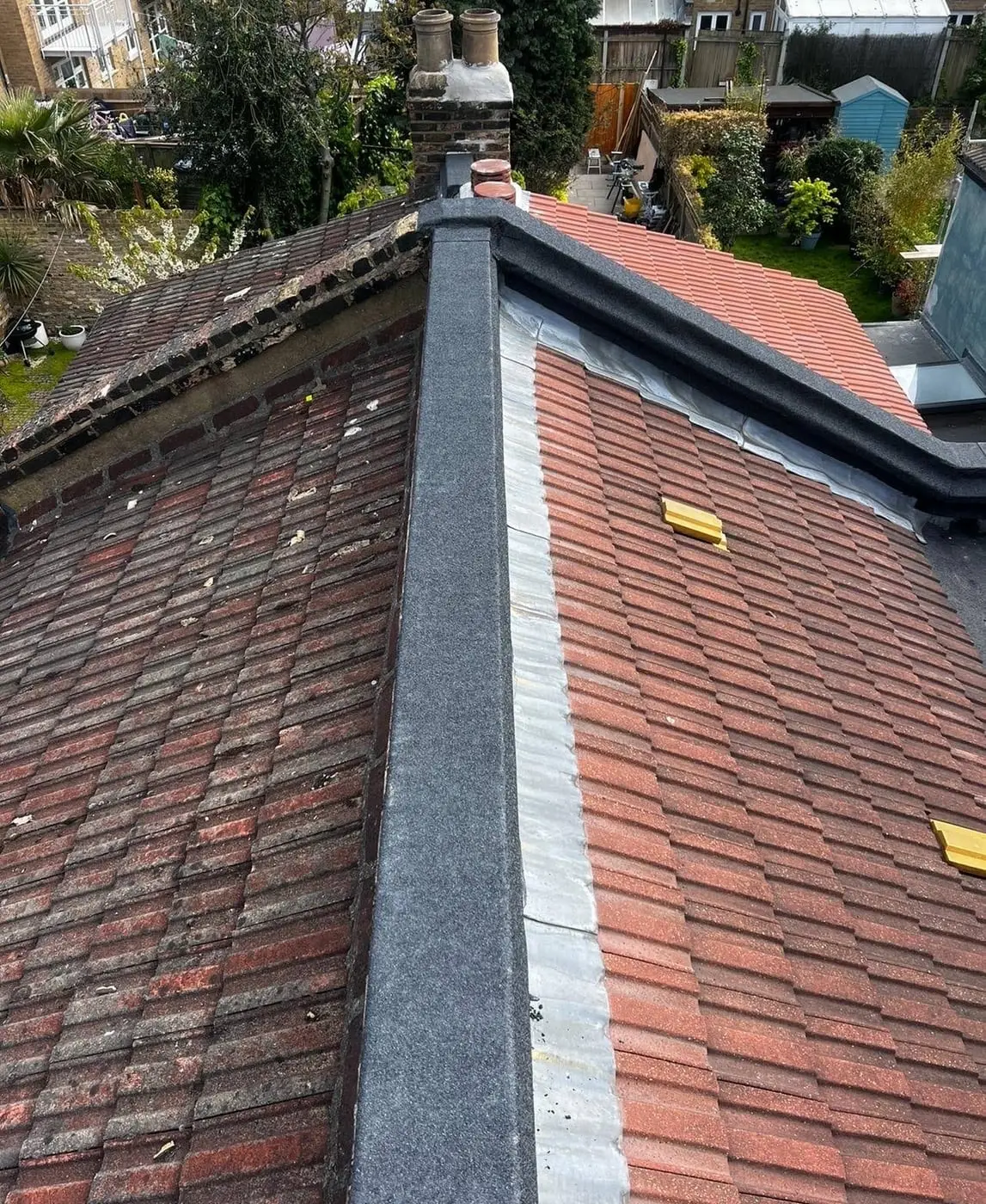 New lead valley running between clay tiled roof slopes on a London property