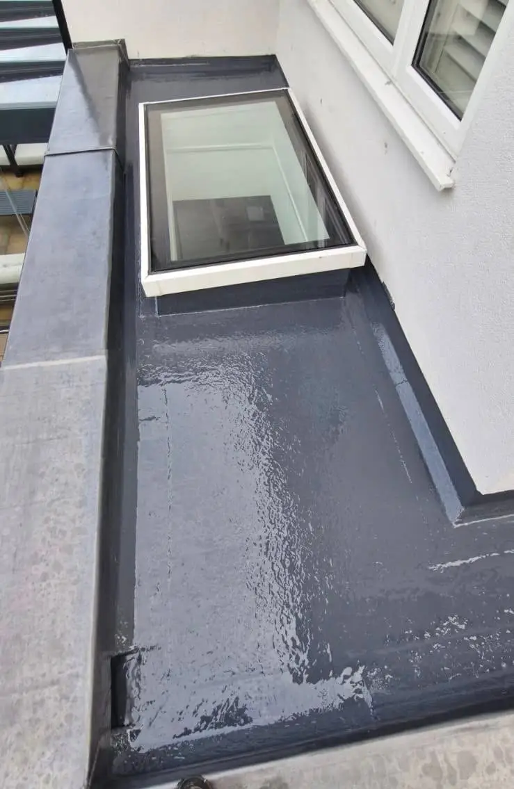 Liquid waterproofed flat roof finished up to a rooflight and parapet upstand