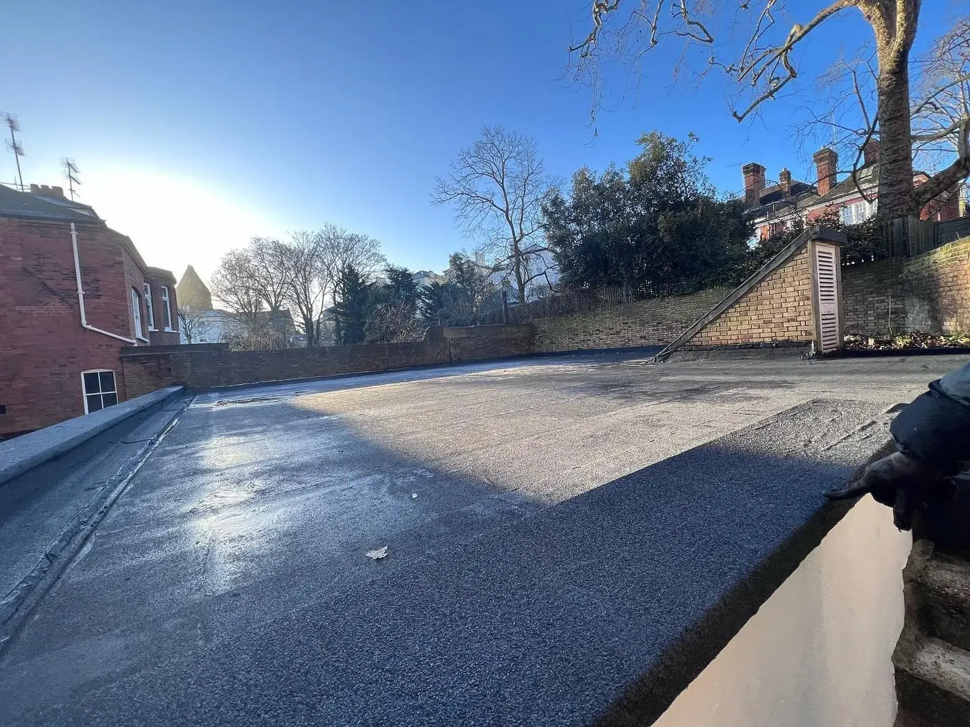 Large newly installed flat roof with rooflights and clean upstand detailing in London