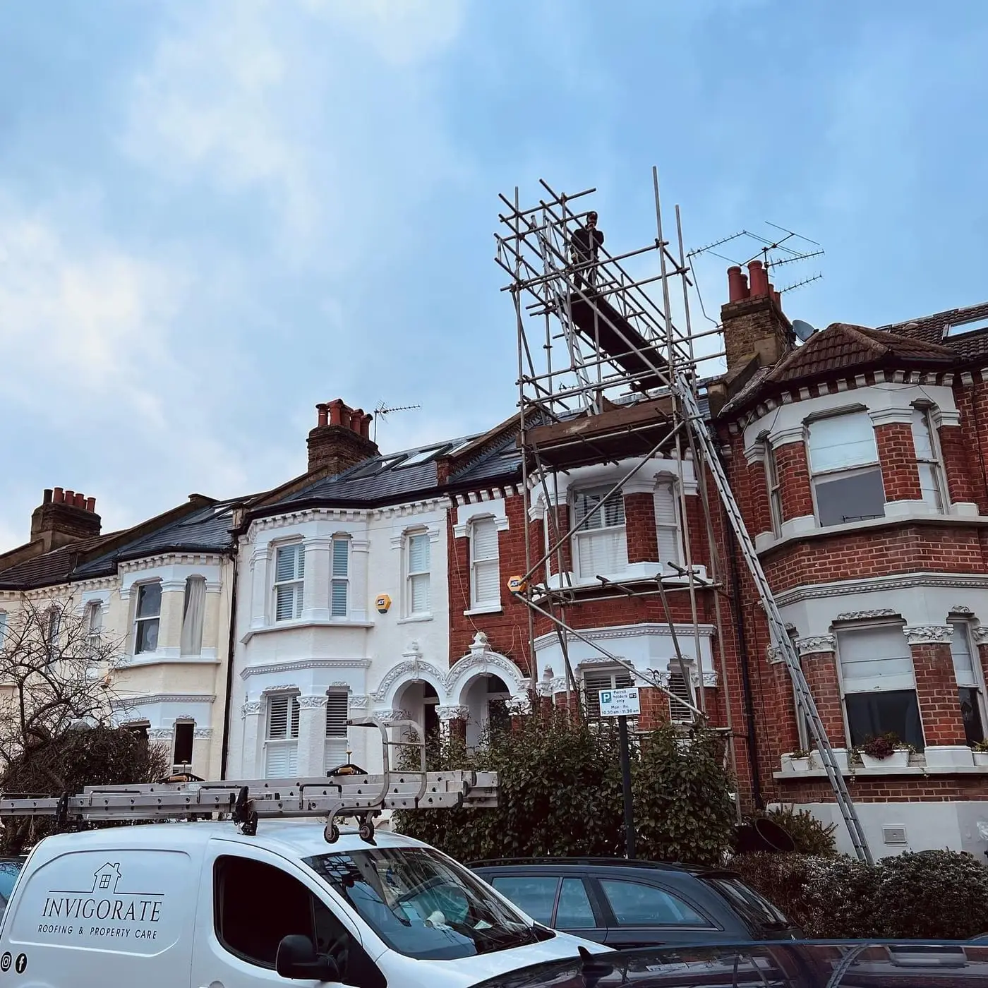 Scaffolded Victorian terrace in London during roofing works