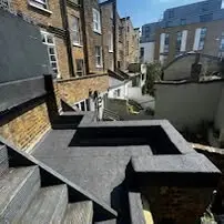Stepped flat roof extension with a fresh covering, overlooking London rooftops